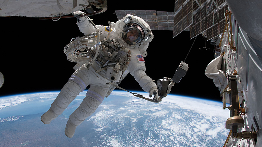 NASA astronaut Drew Feustel is pictured tethered to the International Space Station