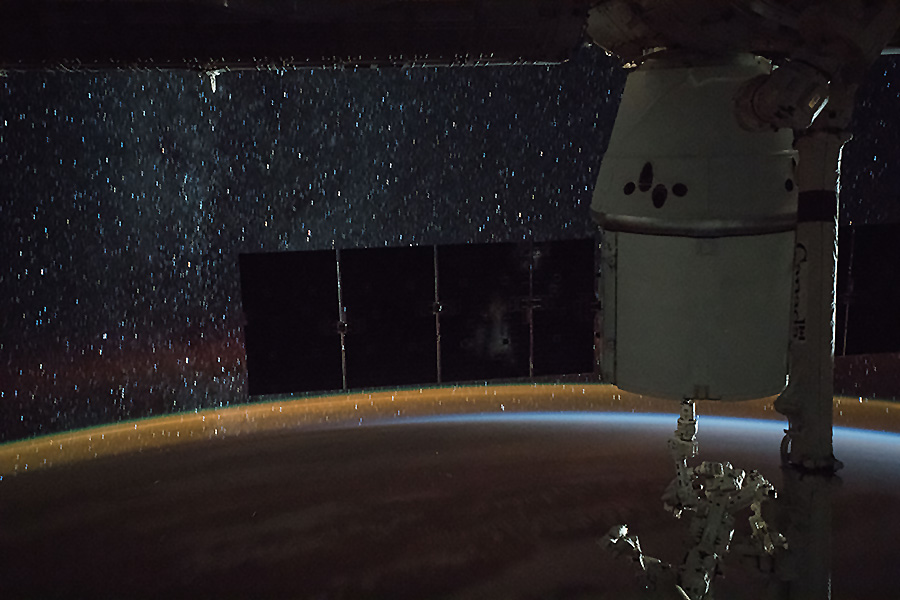 SpaceX Dragon, a star-lit sky and Earth's atmospheric glow