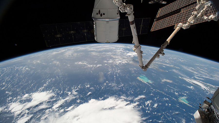 The SpaceX Dragon and the International Space Station orbit above the Bahamas