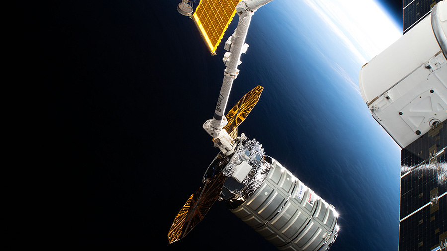 The Cygnus space freighter is poised for release from the Canadarm2