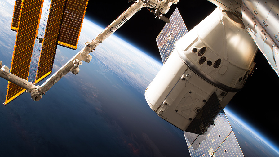 The SpaceX Dragon cargo craft is pictured attached to the International Space Station's Harmony module