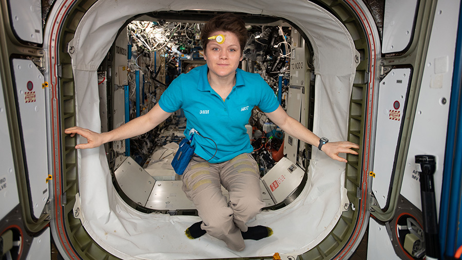 Astronaut Anne McClain is pictured wearing a sensor on her forehead