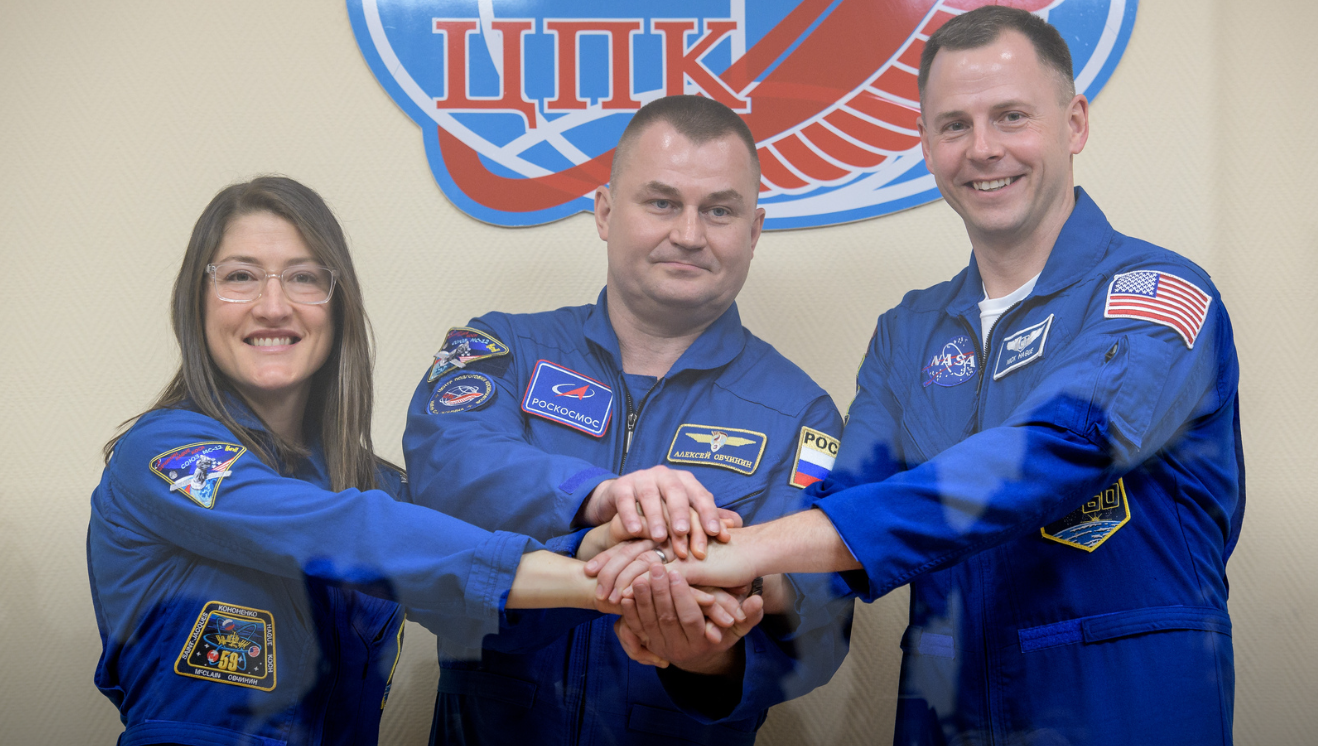 From left, Expedition 59 crew members Christina Koch, Alexey Ovchinin and Nick Hague show solidarity before their upcoming launch from Baikonur, Kazakhstan. 