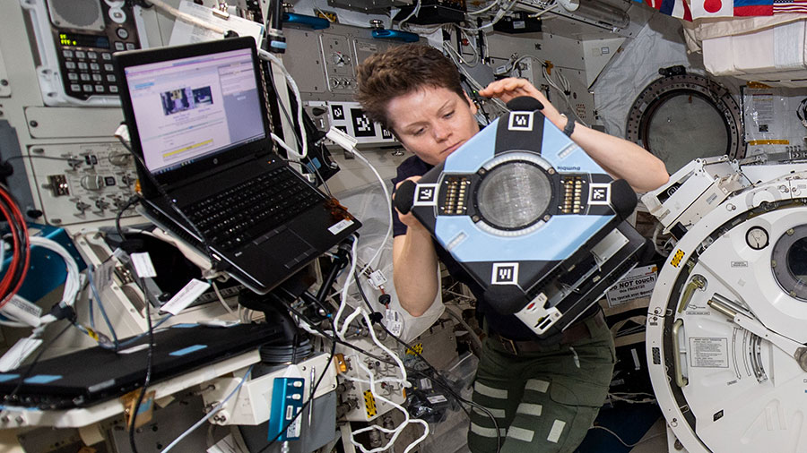 Astronaut Anne McClain checks out the new Astrobee hardware