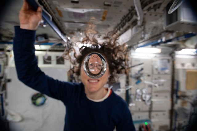 Expedition 60 Flight Engineer Christina Koch of NASA playfully demonstrates how fluids behave in the weightless environment of microgravity aboard the International Space Station. Credit: NASA