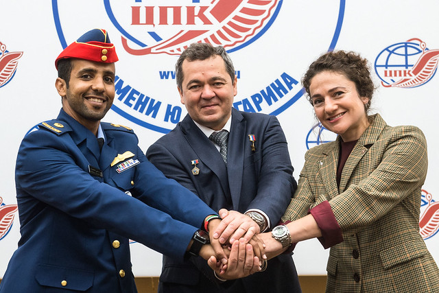 At the Gagarin Cosmonaut Training Center in Star City, Russia, spaceflight participant Hazzaa Ali Almansoori of the United Arab Emirates (left), Oleg Skripochka of Roscosmos (center) and Jessica Meir of NASA (right) pose for pictures Sept. 5 as part of a pre-flight news conference. They will launch Sept. 25 from the Baikonur Cosmodrome in Kazakhstan on the Soyuz MS-15 spacecraft for a mission on the International Space Station. Credit: Gagarin Cosmonaut Training Center