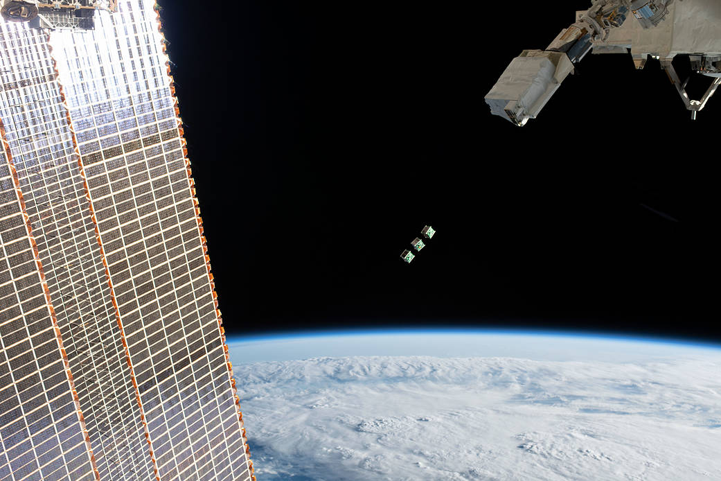 This Wednesday, three small satellites will be deployed from the International Space Station. Here, a set of three CubeSats are ejected from the Japanese Small Satellite Orbital Deployer attached to a robotic arm outside the Japan Aerospace Exploration Agency's Kibo laboratory module on June 17, 2019. Image Credit: NASA