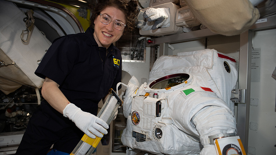 NASA astronaut Christina Koch works on a U.S. spacesuit