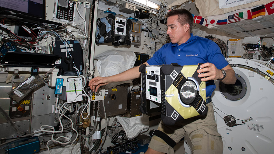 63 Commander Chris Cassidy sets up an Astrobee robotic assistant