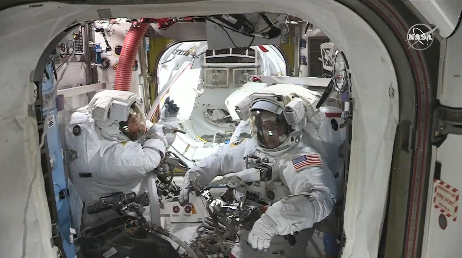 Spacewalkers Bob Behnken (left) and Chris Cassidy (right) in the Quest Airlock before beginning today’s spacewalk. Credit: NASA TV