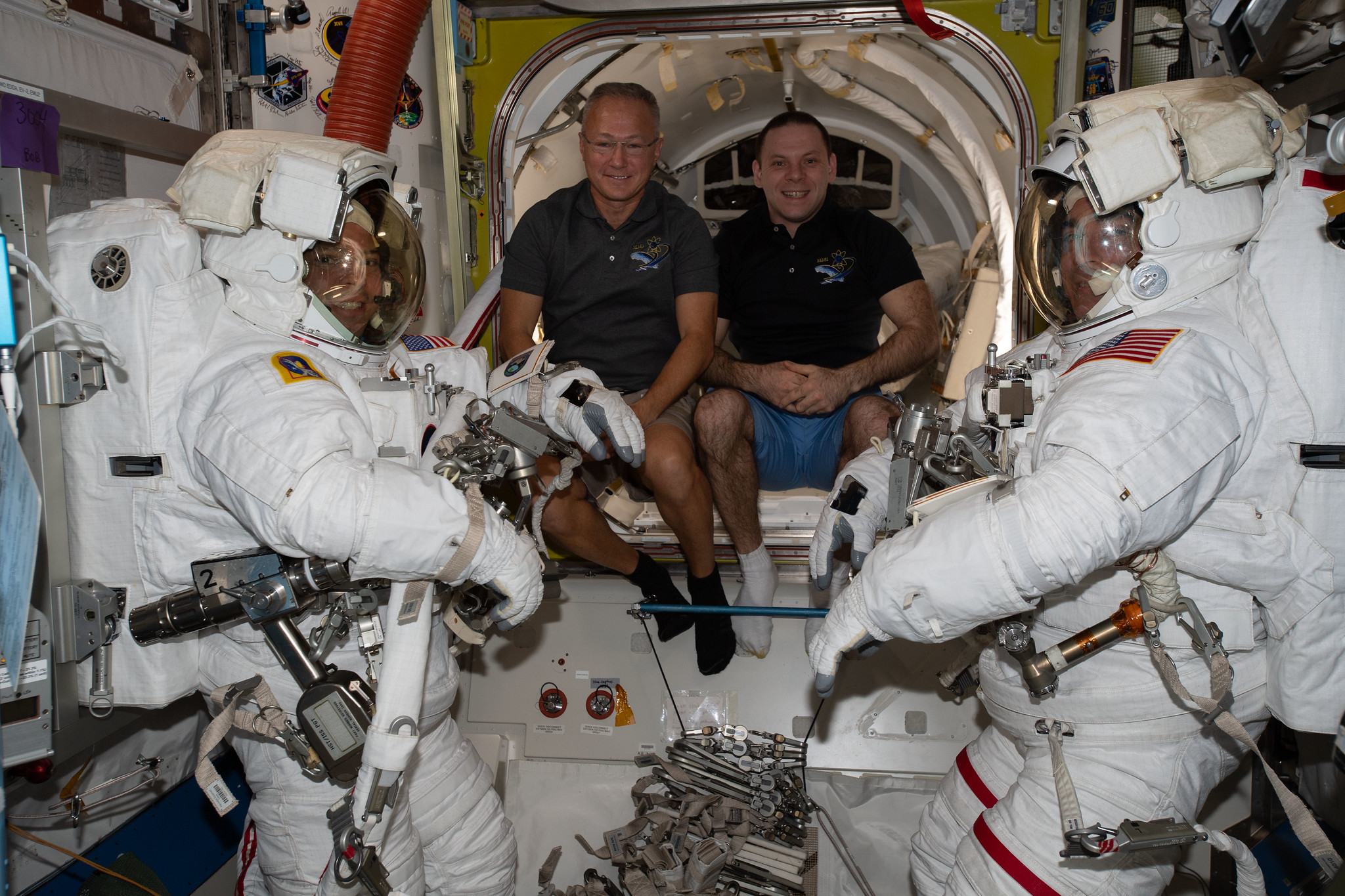 Spacewalkers Bob Behnken (far left) and Chris Cassidy (far right) are suited up ahead of their June 26 spacewalk.