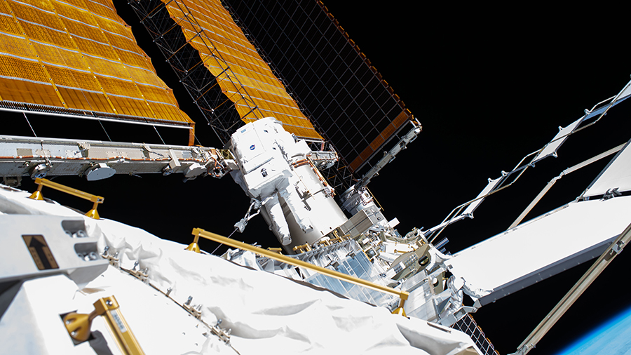 Flight Engineer Bob Behnken (center) is pictured on July 1 during a spacewalk to swap an aging nickel-hydrogen battery for a new lithium-ion battery on the station's starboard truss structure.