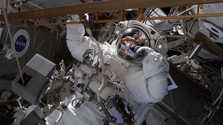 Astronaut Bob Behnken works during a spacewalk to swap an aging nickel-hydrogen battery for a new lithium-ion battery.