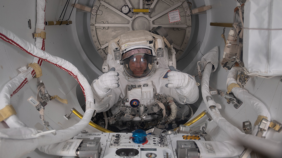 Expedition 63 Commander Chris Cassidy is pictured in his U.S. spacesuit halfway inside the crew lock portion of the Quest airlock during a spacewalk on July 1, 2020.