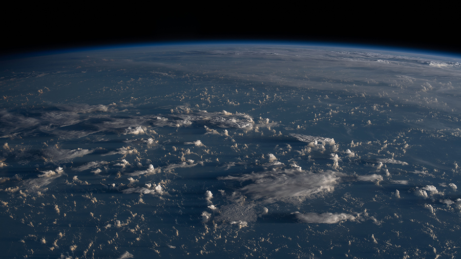 Sunrise casts long shadows from the clouds across the Philippine Sea