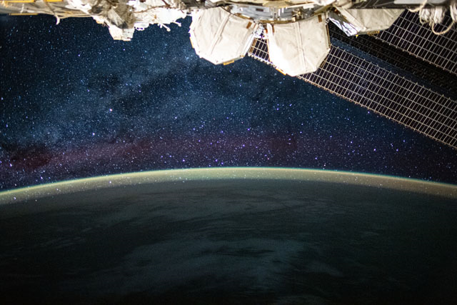 This long-exposure photograph from the International Space Station was taken during an orbital night period and reveals the Milky Way glittering above a bright but exaggerated atmospheric glow that blankets the Earth's horizon. Credits: NASA