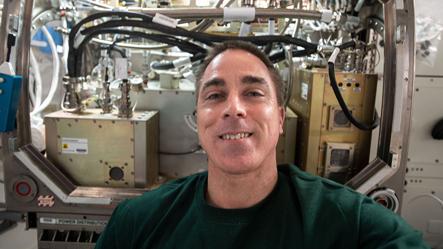 NASA astronaut and Expedition 63 Commander Chris Cassidy poses for a portrait in front of the Microgravity Science Glovebox.