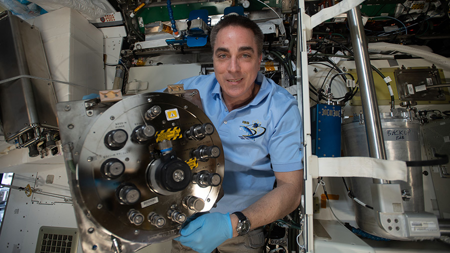 Expedition 63 Commander Chris Cassidy replaces components inside the Waste and Hygiene Compartment, the International Space Station's bathroom located inside the Tranquility module.