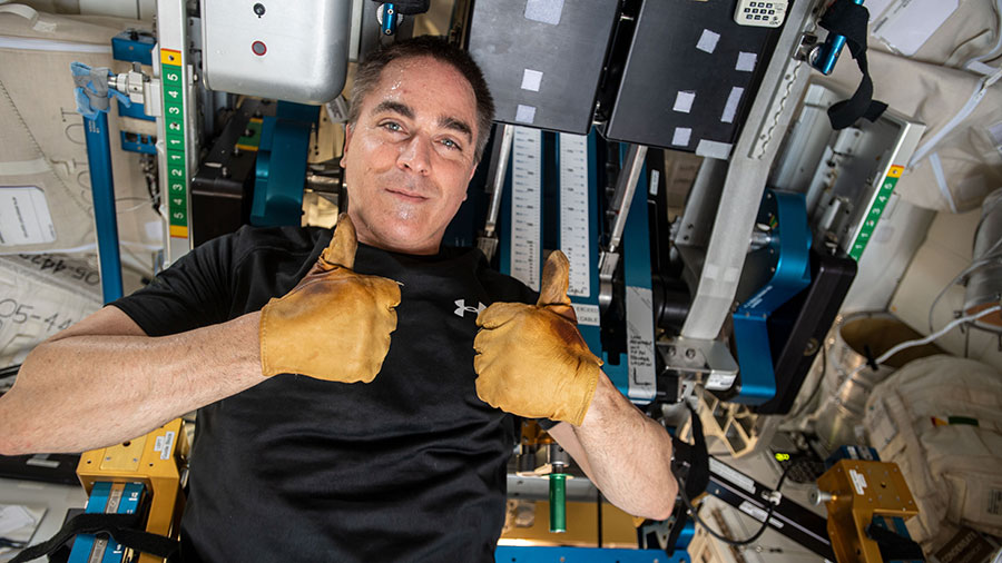 Expedition 63 Commander Chris Cassidy gives a thumbs up during set up of space station exercise equipment.