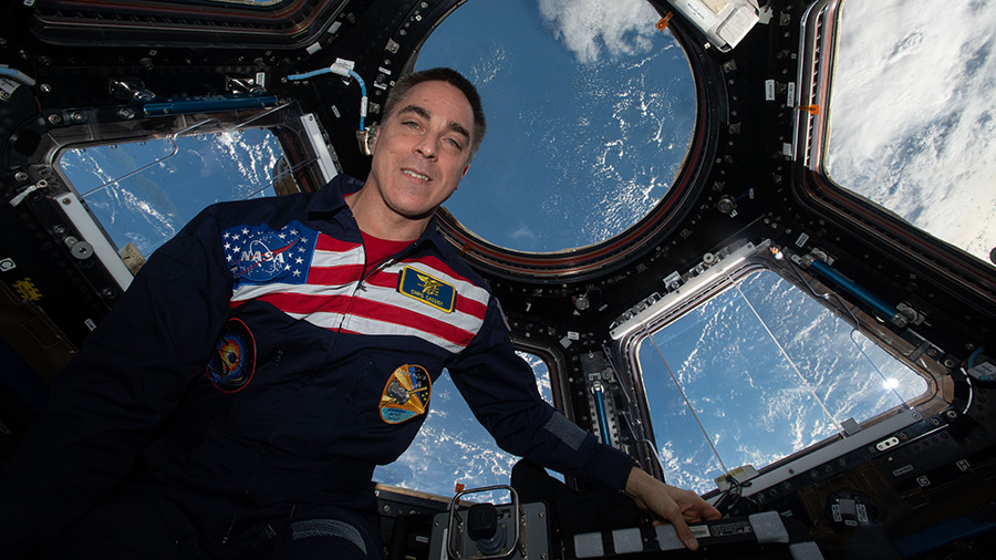 Expedition 63 Commander Chris Cassidy poses for a portrait wearing his flight suit inside the cupola, the International Space Station's window to the world.