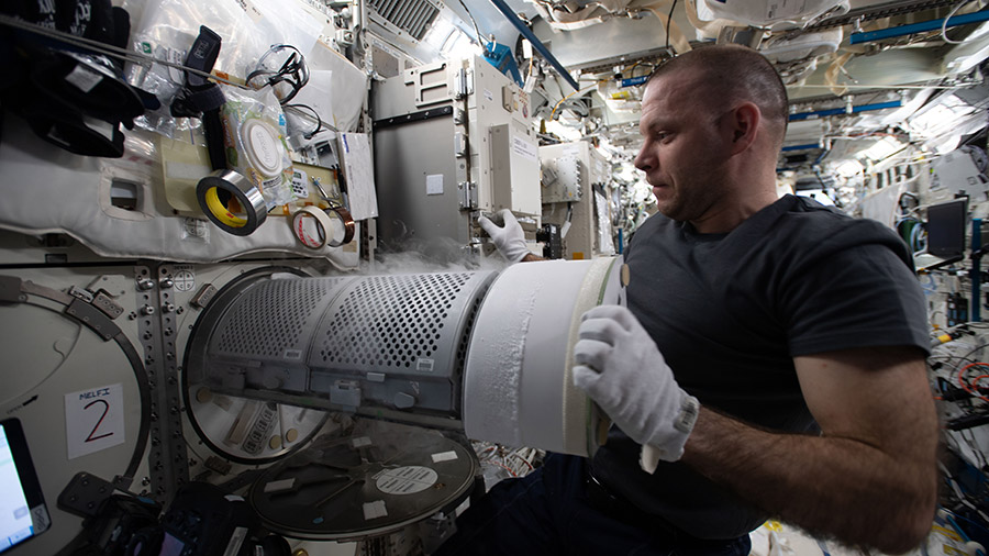 Expedition 63 Flight Engineer Ivan Vagner transfers biological samples into a science freezer for stowage and later analysis aboard the International Space Station.