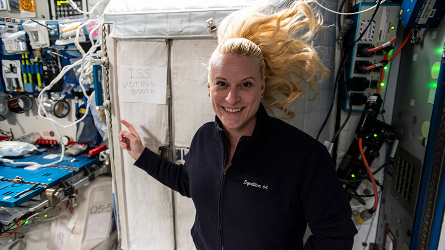 NASA astronaut and Expedition 64 Flight Engineer Kate Rubins points to the International Space Station's "voting booth" where she cast her vote from space this month.