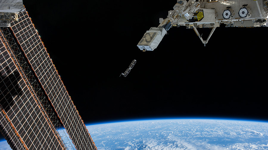 A set of CubeSats is pictured after being deployed from a small satellite deployer outside Japan's Kibo laboratory module in February of 2014.