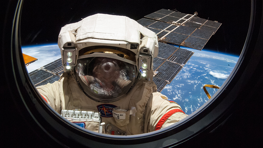 Cosmonaut Alexander Skvortsov is pictured wearing a Russian Orlan spacesuit during a spacewalk outside of the International Space Station in August of 2014.