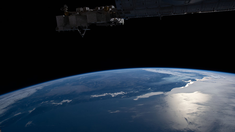 The Sun's glint beams off the Pacific Ocean and San Francisco Bay as the space station orbited off the coast of California.