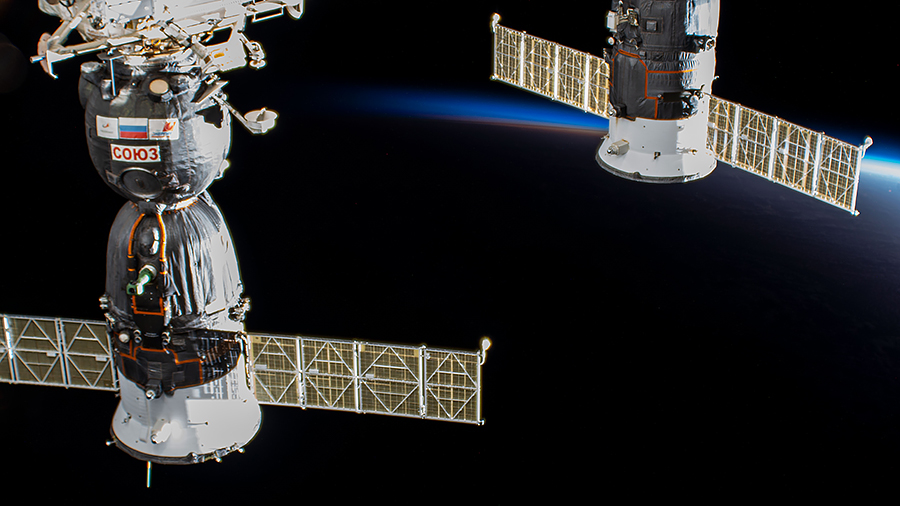 A pair of docked Russian spaceships, (from left) the Soyuz MS-17 crew ship and the Progress 76 cargo craft, are pictured as the International Space Station orbited above the Atlantic Ocean during an orbital sunset.