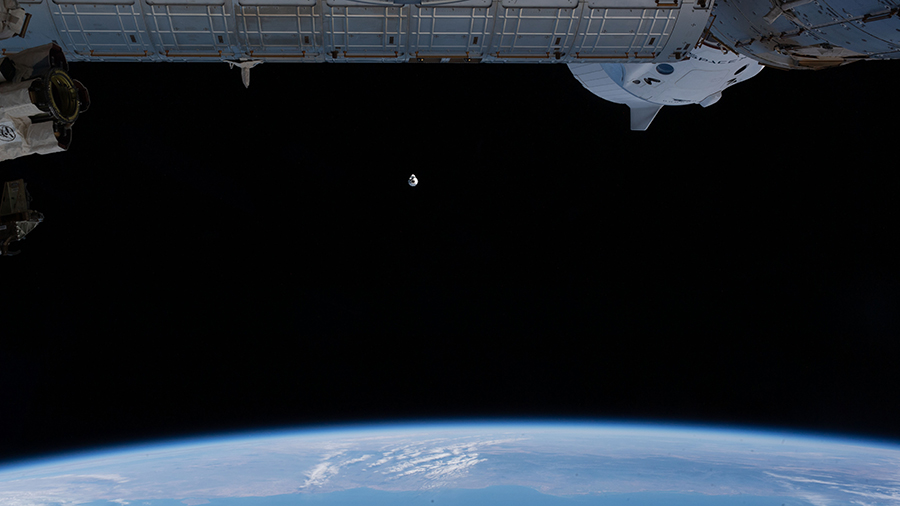 The upgraded SpaceX Cargo Dragon vehicle approaches the space station as both vehicles were orbiting above the Pacific Ocean off the coast of Mexico.