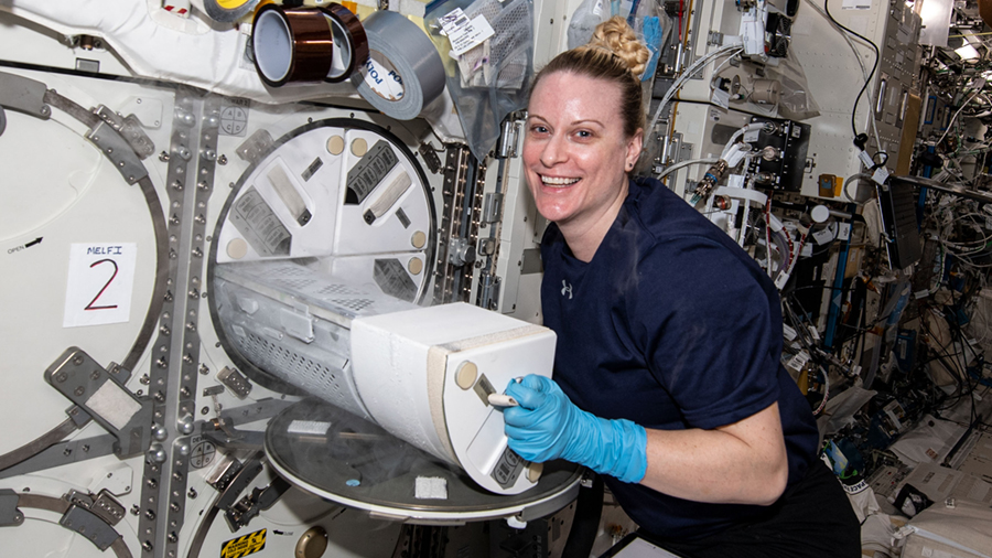 NASA astronaut Kate Rubins loads engineered heart tissue samples into a science freezer for preservation and later analysis.