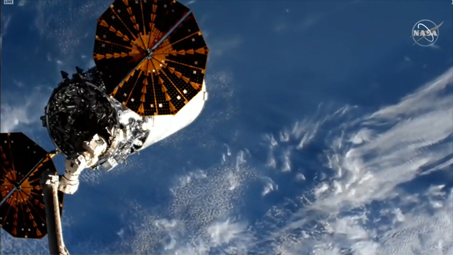 The Cygnus space freighter is pictured in the grips of the Canadarm2 robotic arm moments before its release completing a 93-day stay at the space station. Credit: NASA TV