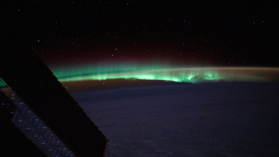 Earth's atmospheric glow and the aurora blanket the horizon as the space station orbited above the North Atlantic.