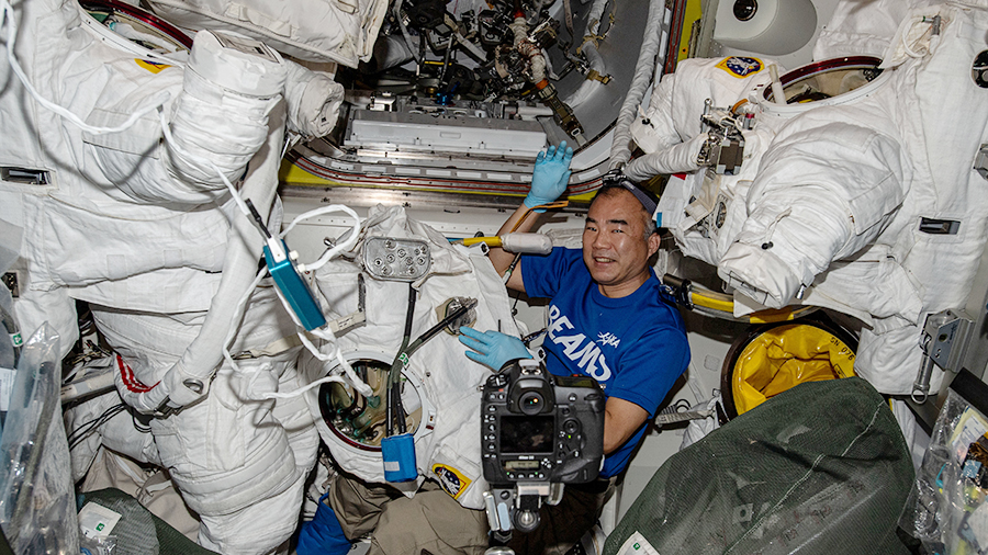 JAXA (Japan Aerospace Exploration Agency) astronaut Soichi Noguchi works on U.S. spacesuit gear inside the Quest airlock.