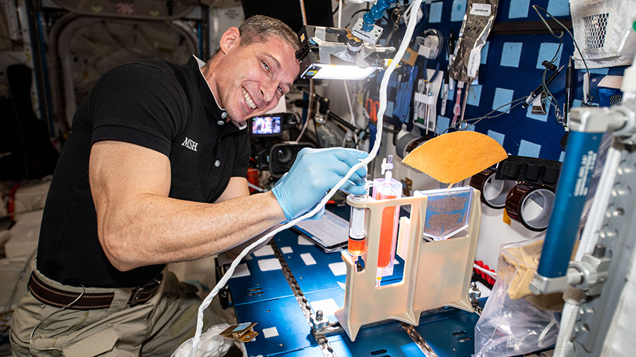 Expedition 64 Flight Engineer Michael Hopkins works on hydroponics components for the Plant Water Management study.