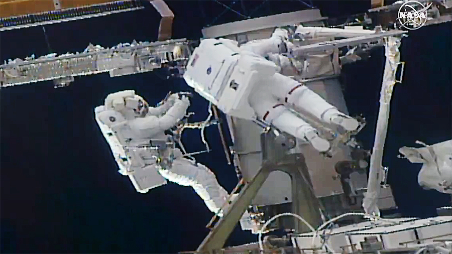 (From left) Astronauts Kate Rubins and Soichi Noguchi work to install a solar array modification kit during the fourth spacewalk of both of their careers. Credit: NASA