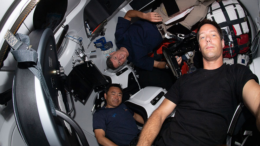 Expedition 65 astronauts (clockwise from bottom) Akihiko Hoshide, Shane Kimbrough and Thomas Pesquet are pictured inside the SpaceX Crew Dragon Resilience.