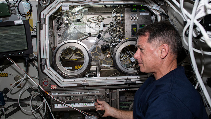 NASA astronaut Shane Kimbrough sets up hardware for the SUBSA physics investigation in the Microgravity Science Glovebox.