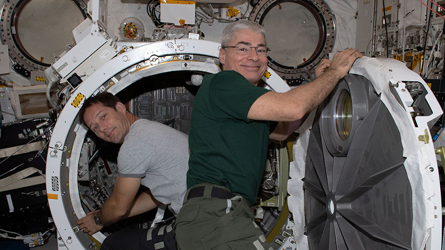 Astronauts (from left) Thomas Pesquet and Mark Vande Hei set up the Kibo laboratory module's airlock for the installation of an experiment platform.