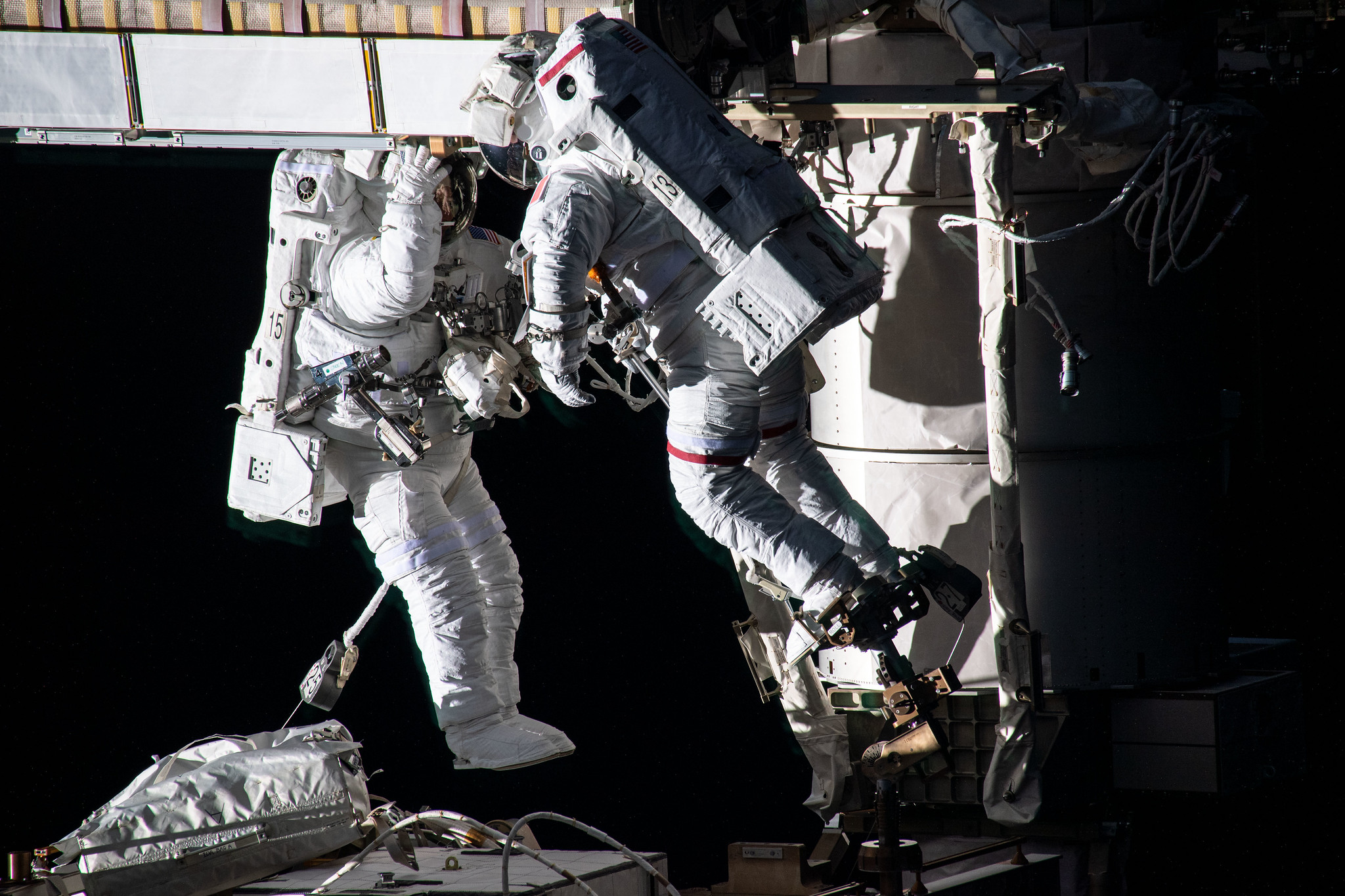 Spacewalkers (from left) Shane Kimbrough and Thomas Pesquet work to install new roll out solar arrays on the International Space Station's P-6 truss structure on June 16, 2021.