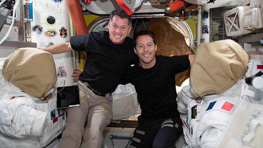 Astronauts Shane Kimbrough (from left) and Thomas Pesquet pose for a portrait while working on U.S. spacesuits. 