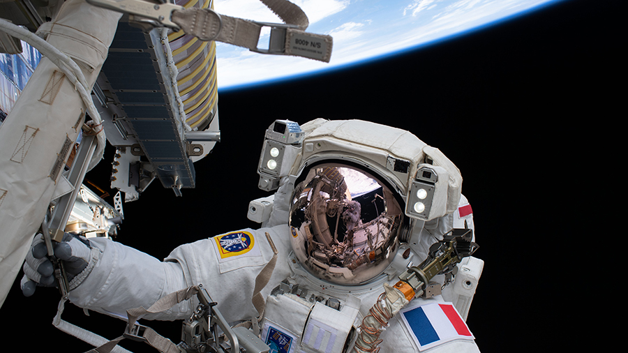 Spacewalker Thomas Pesquet of ESA (European Space Agency) works to complete the installation of a roll out solar array on the International Space Station's Port-6 truss structure.