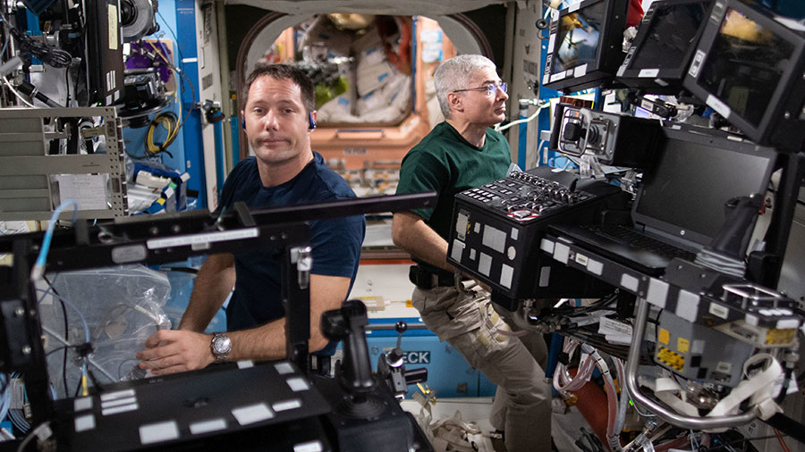 Astronauts (from left) Thomas Pesquet and Mark Vande Hei service a variety of hardware inside the U.S. Destiny laboratory module.