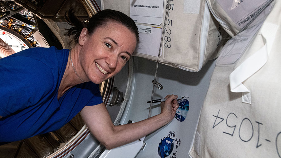 Astronaut Megan McArthur signs her name next to the SpaceX CRS-22 cargo mission sticker before the Cargo Dragon's departure last week.