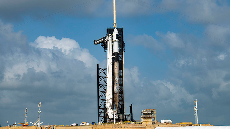 The Falcon 9 rocket form SpaceX with the Cargo Dragon spacecraft atop stands at the launch pad at NASA's Kennedy Space Center in Florida. Credit: SpaceX