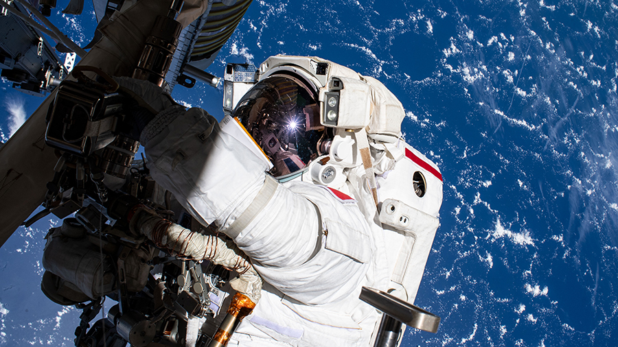 Astronaut Thomas Pesquet works during a spacewalk on June 25 to install the second roll out solar array on the station's Port-6 truss structure.