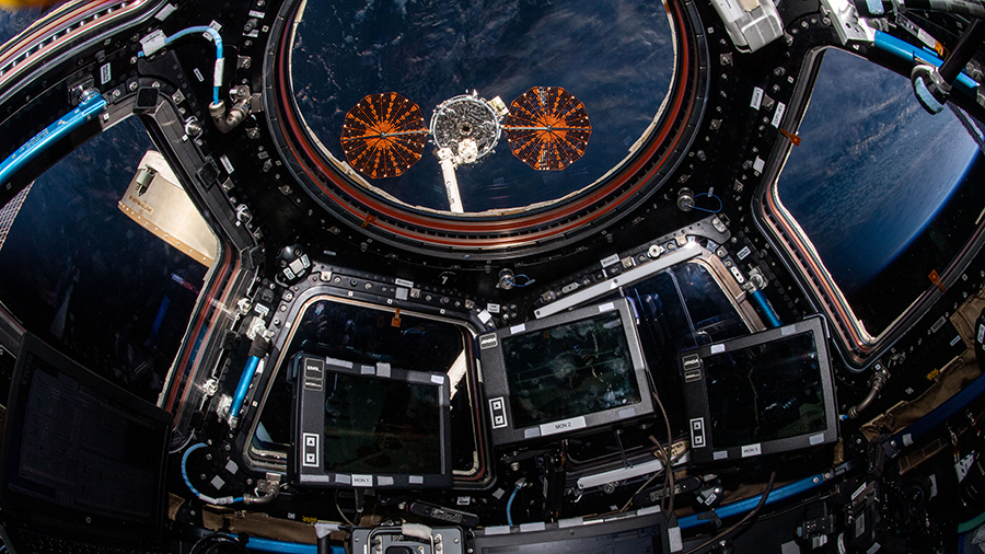 The Cygnus space freighter from Northrop Grumman is pictured in the grip of the Canadarm2 robotic arm outside the cupola before its release on June 29, 2021.