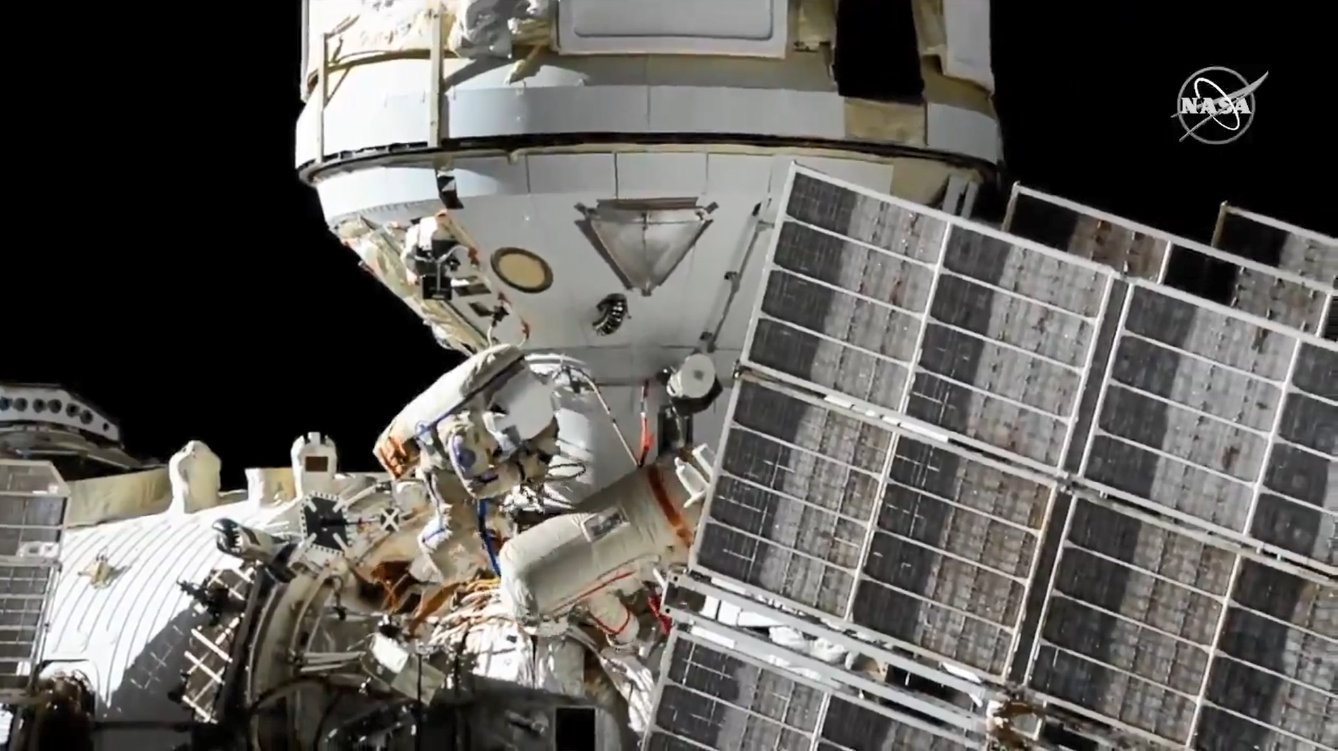 Cosmonauts Oleg Novitskiy and Pyotr Dubrov during a spacewalk to connect power and ethernet cables to the Nauka laboratory module.