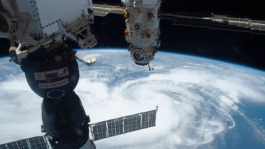 The Soyuz MS-18 crew ship and the Nauka multipurpose laboratory module are pictured above Hurricane Henri in the Atlantic Ocean on Aug. 21, 2021.